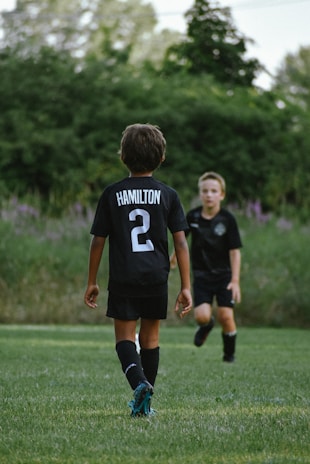 a couple of boys in a field