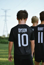 a group of boys in black shirts