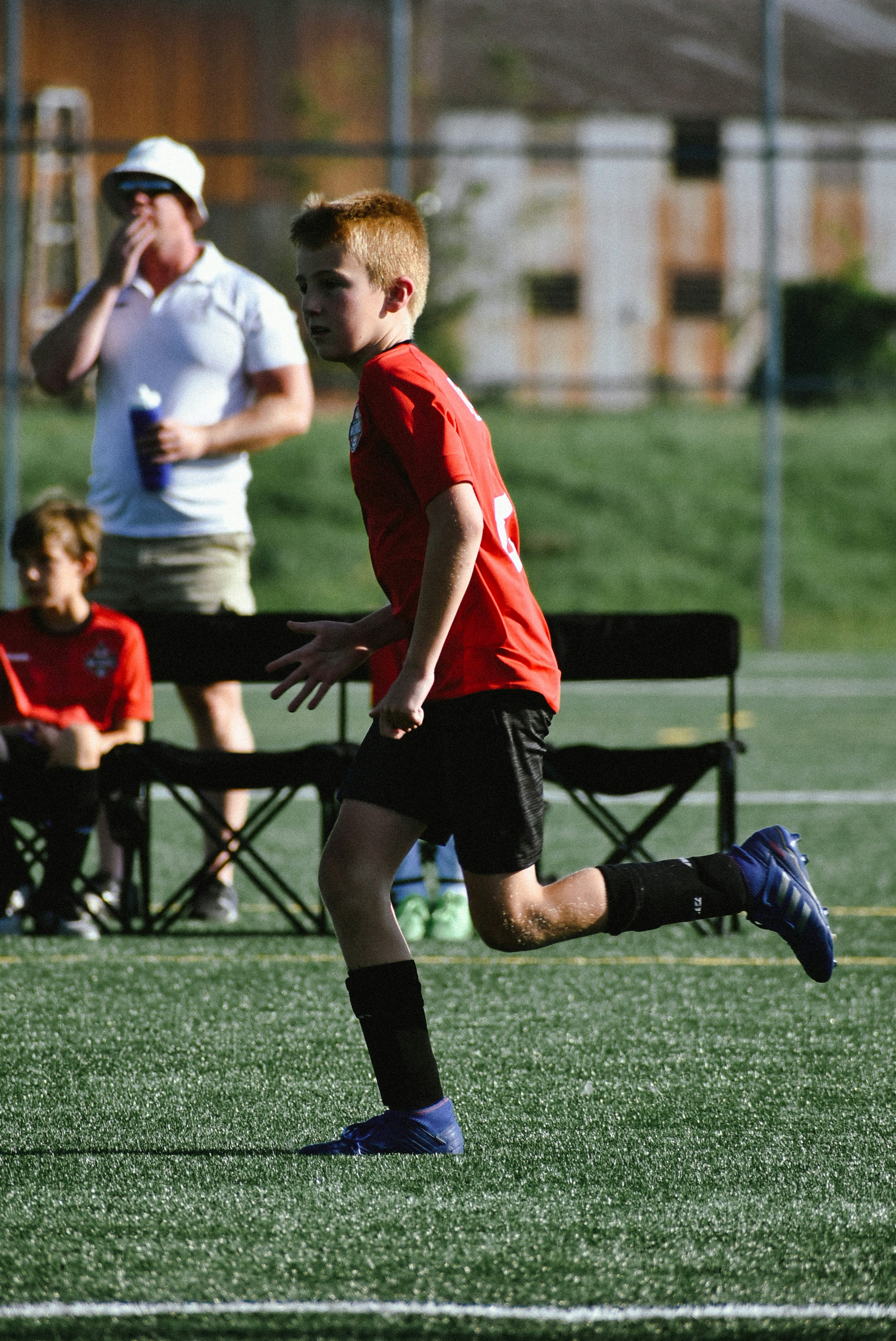 a boy running on a field