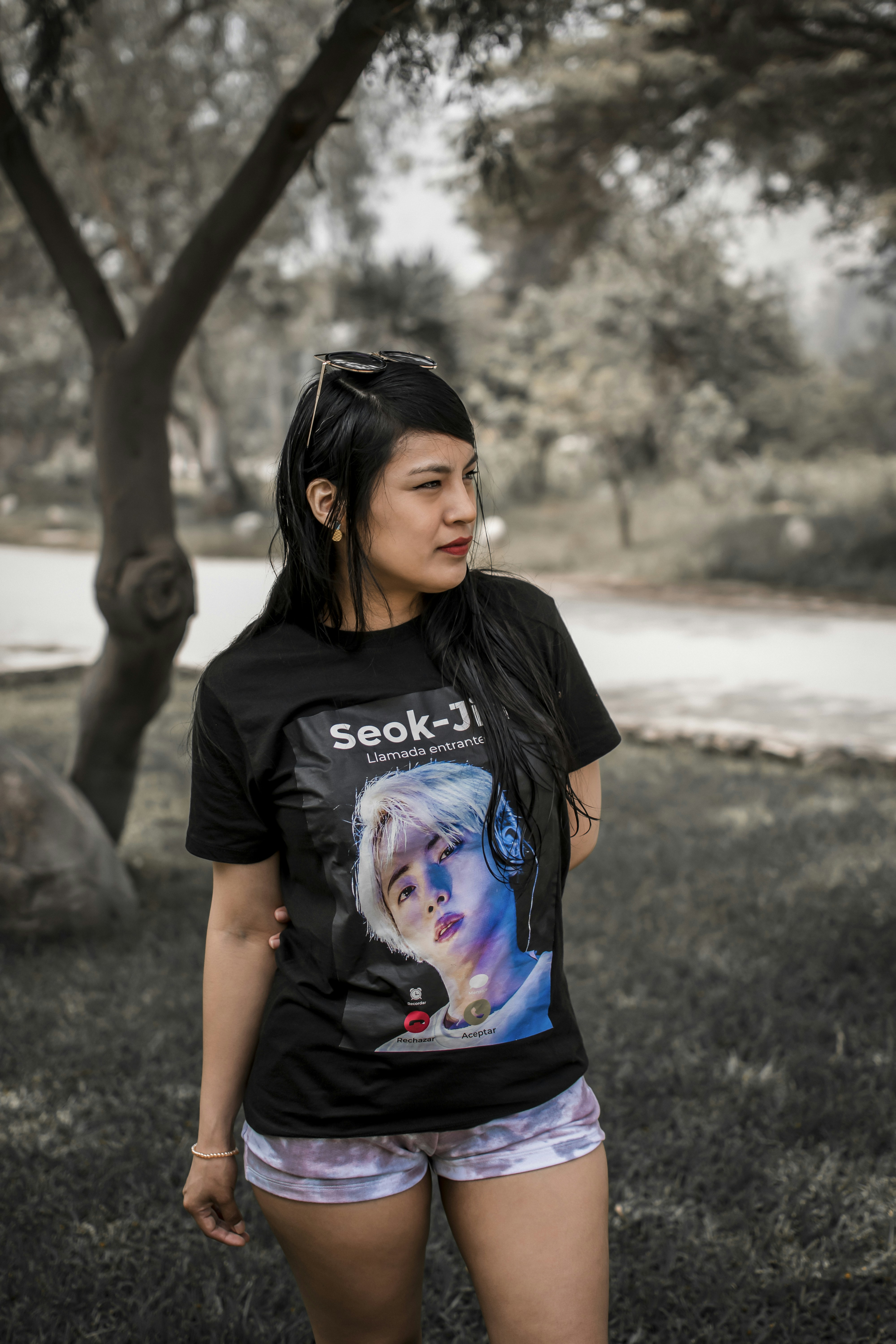 Bright graphic print T-shirt worn outdoors in natural sunlight, vibrant open-air environment