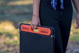a person holding a black box