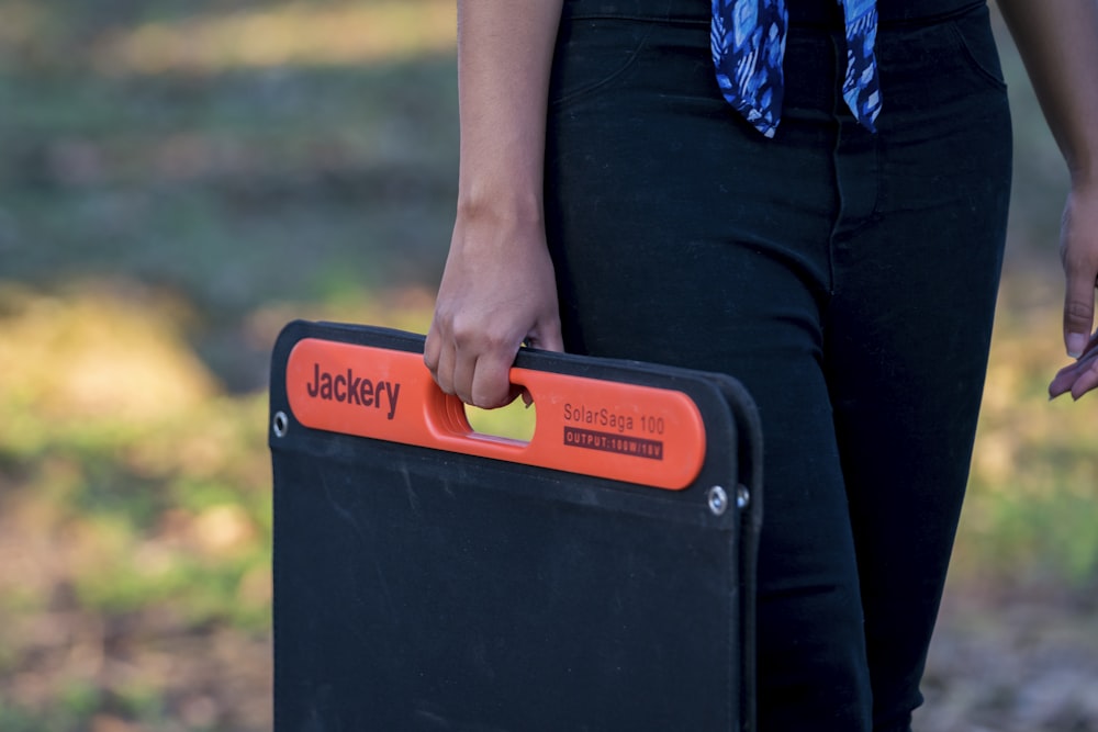 a person holding a black box