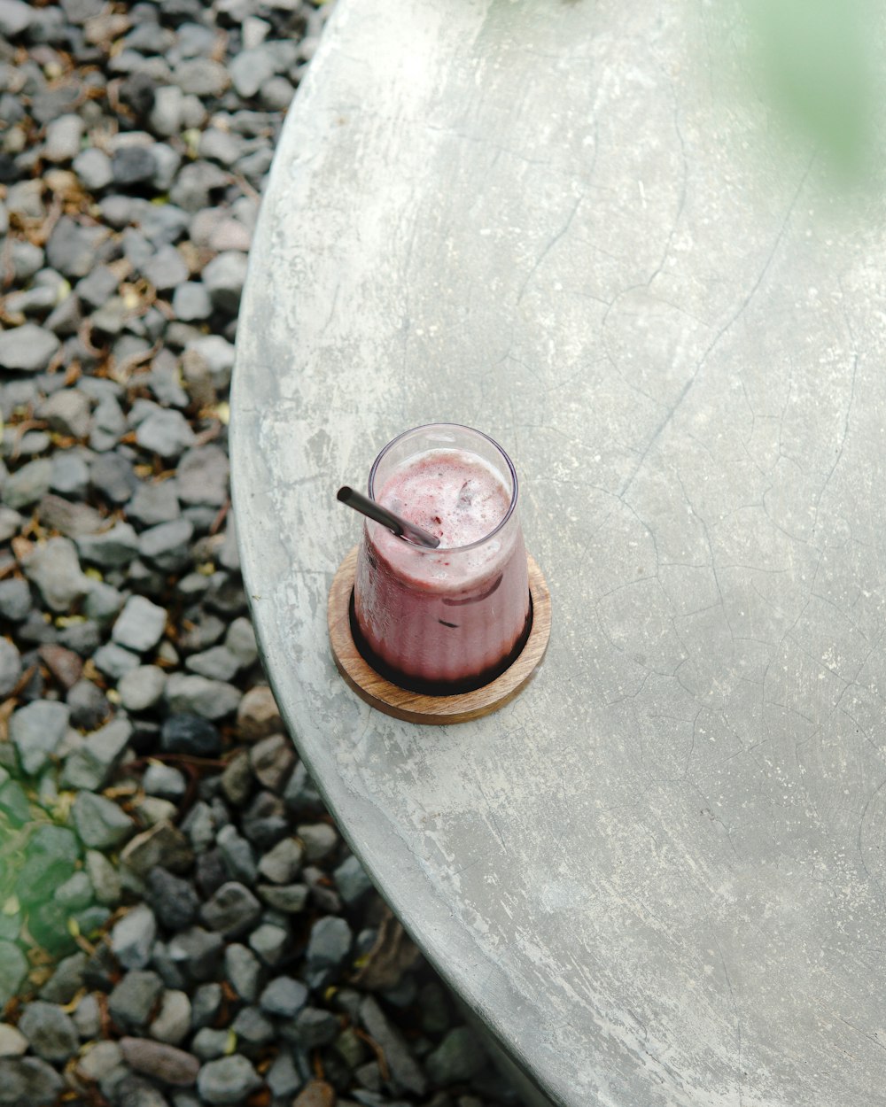 a glass of liquid on a rock