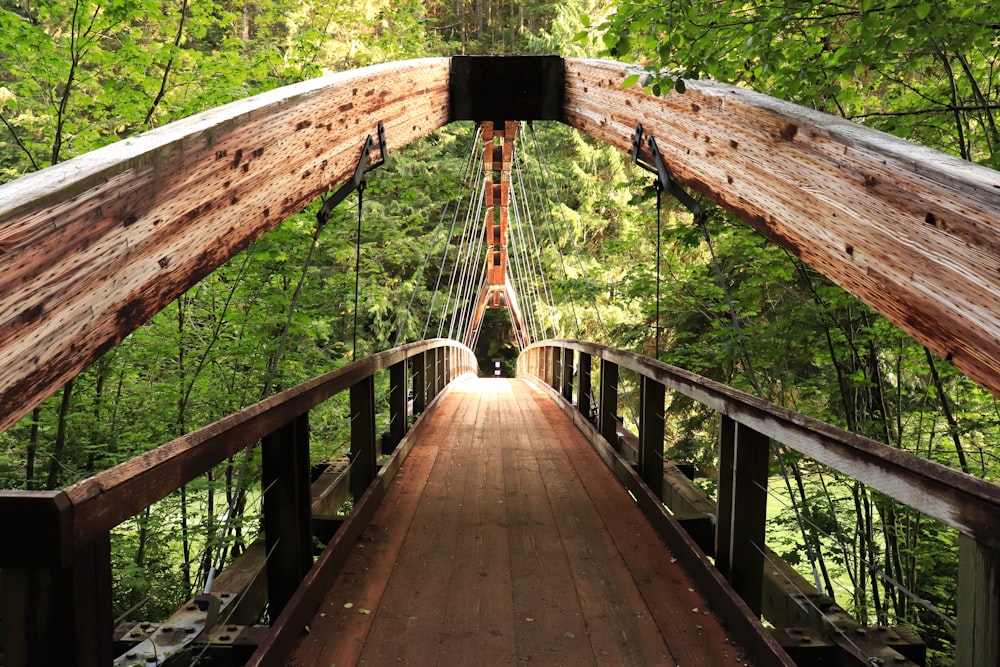 a wooden bridge with a metal railing
