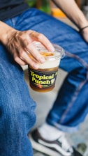 a person holding a jar of food
