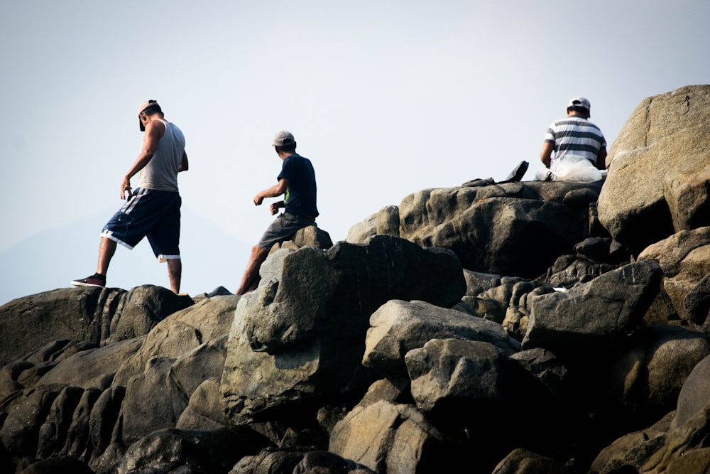 a group of men on rocks