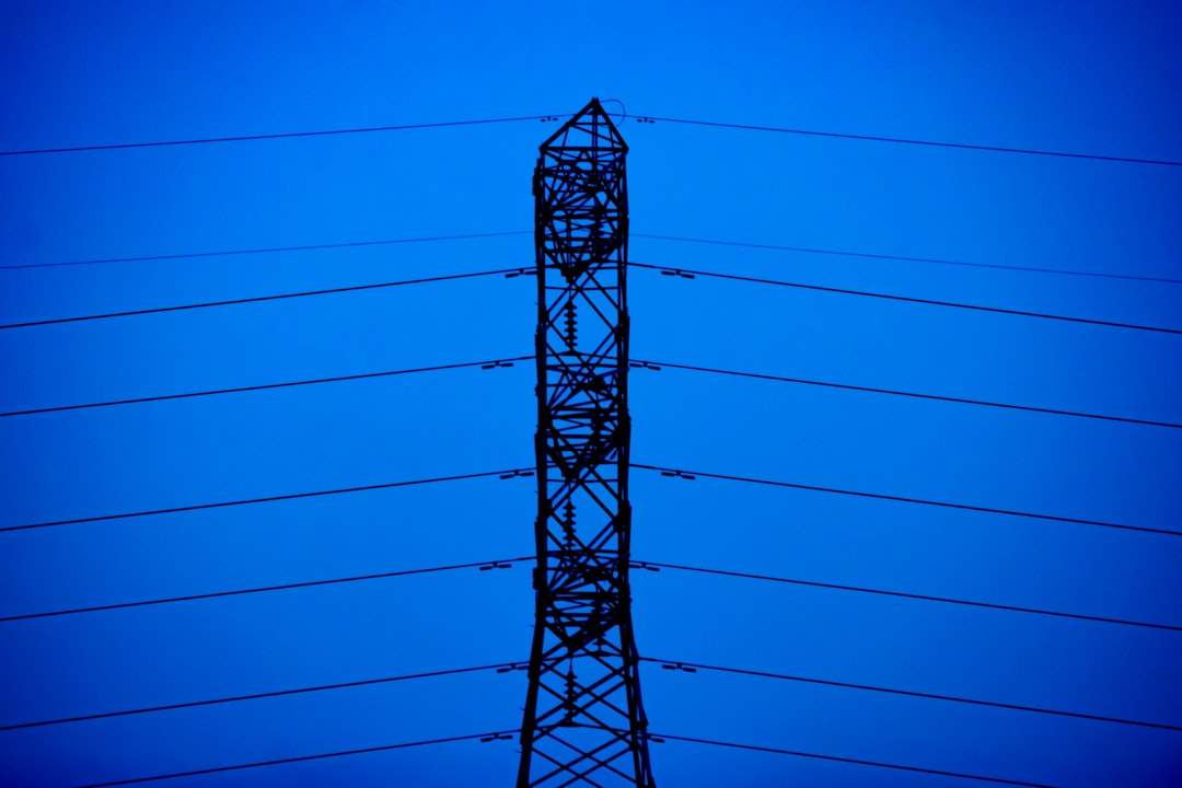 a power line tower, A tall structure, usually a steel lattice tower, is used to support an overhead power line. Structure, lattice tower, and overhead power line