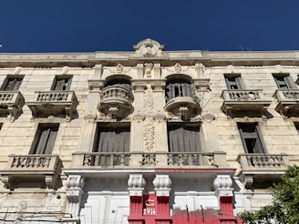 The historic facade of belogradchik narodno chitalishte 'razvitie - 1893' on a sunny day.