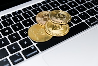 a group of gold coins on a keyboard
