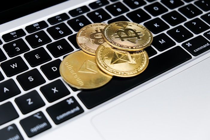 a group of gold coins on a keyboard