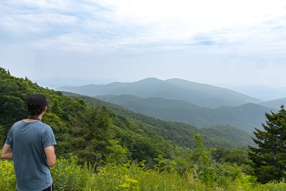 a man looking at a mountain range