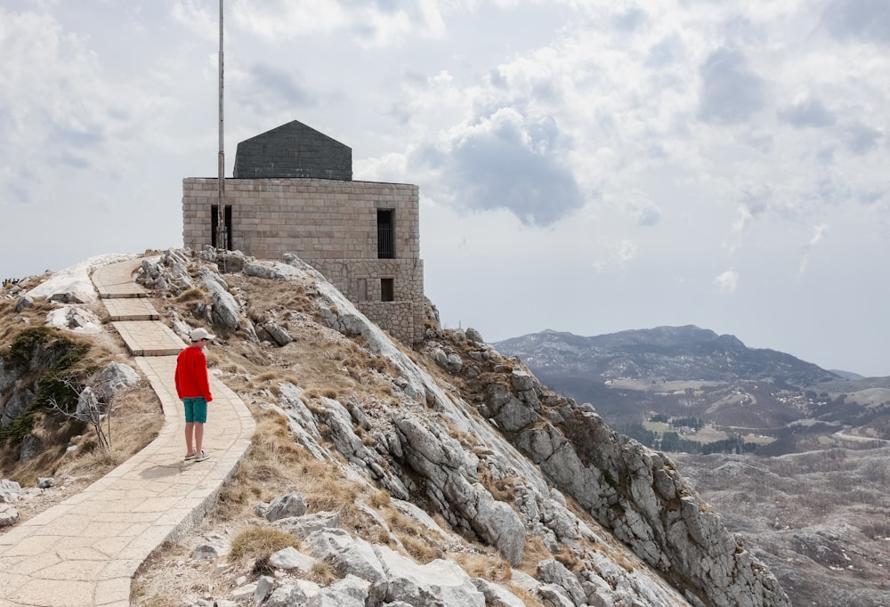 a person standing on a rocky hill