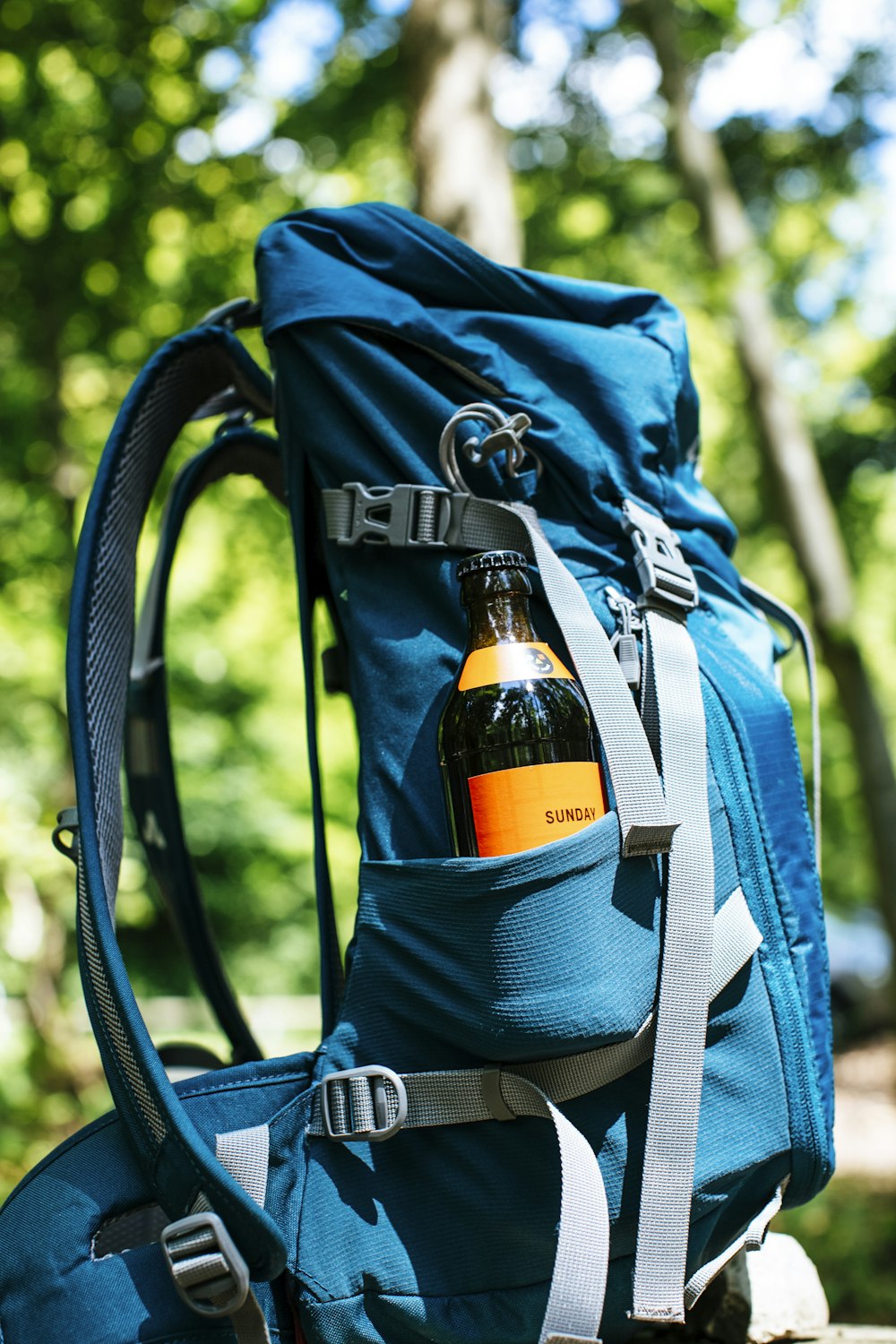 a backpack with a bottle of liquid in it
