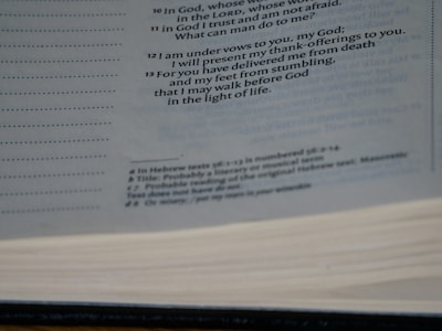 A close-up view of an open book showing printed text on the pages. The text is primarily in black ink and includes headings and footnotes. The image captures the texture of the pages and the layout of the printed lines.