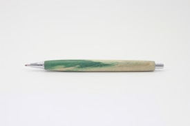 A pen with a wooden body featuring green and beige marbling, complemented by metallic silver accents and a red tip, lying horizontally against a plain white background.