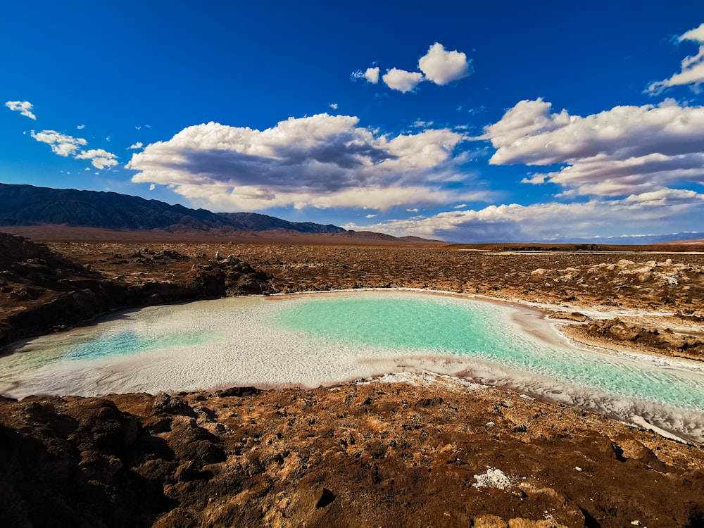 a body of water surrounded by rocky hills