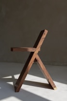 a wooden chair on a white surface