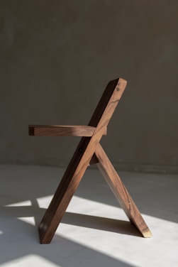 a wooden chair on a white surface