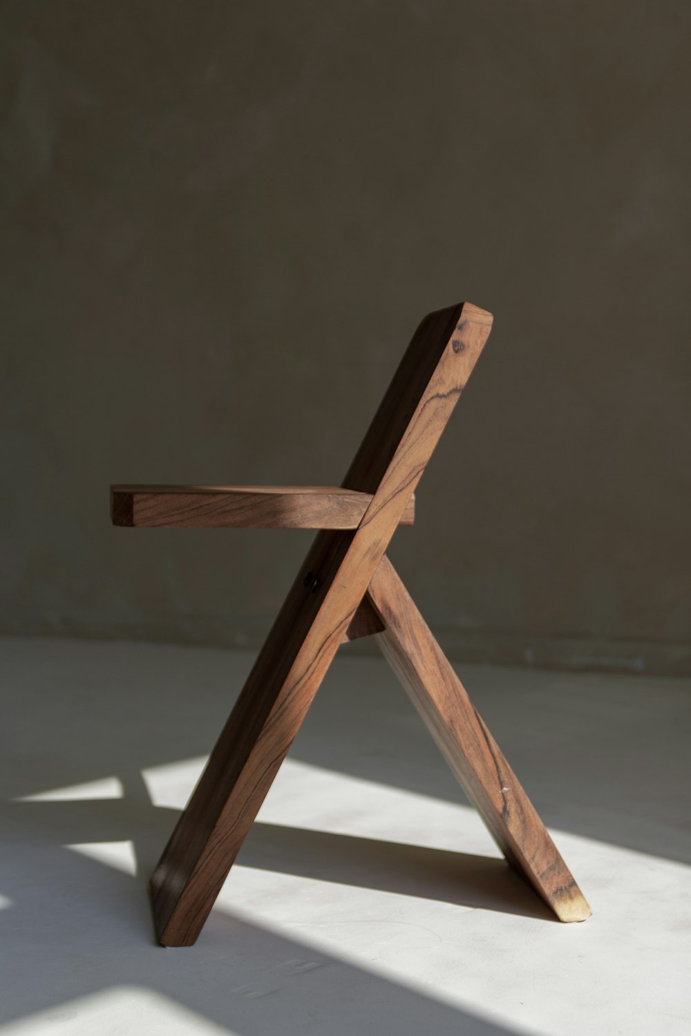 a wooden chair on a white surface