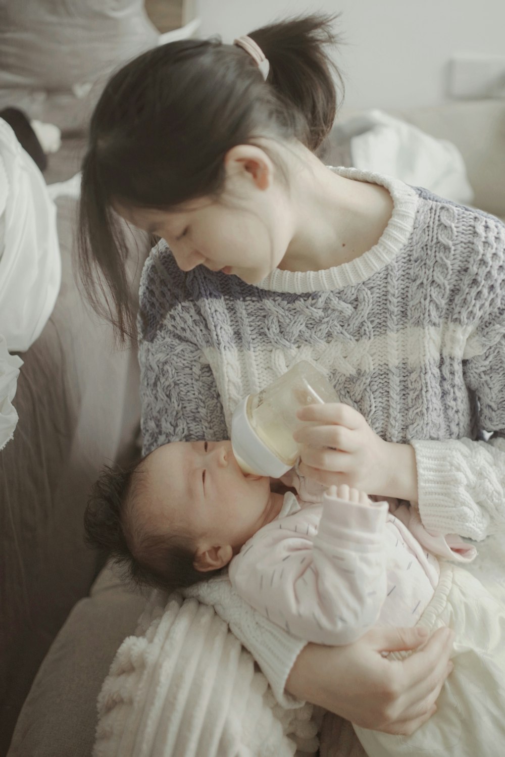 a person feeding a baby