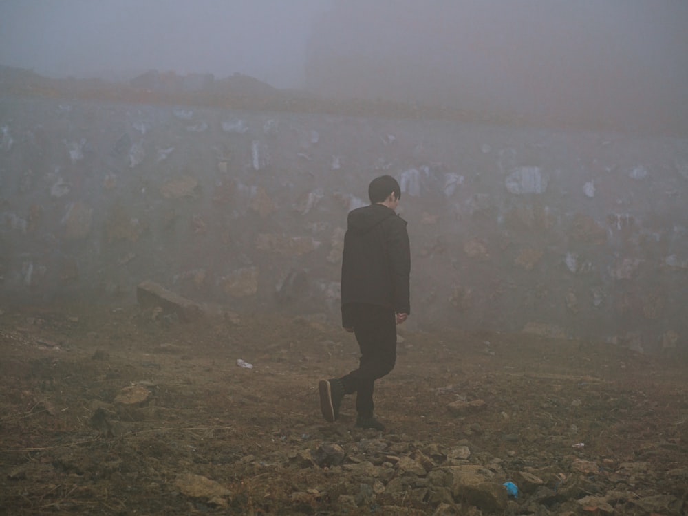 a man walking on a hill