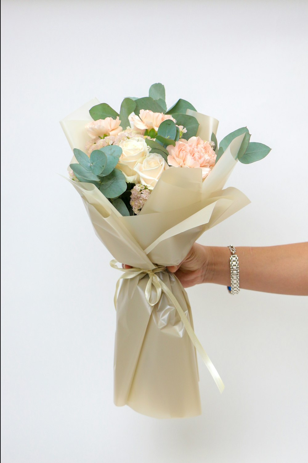 a hand holding a bouquet of flowers