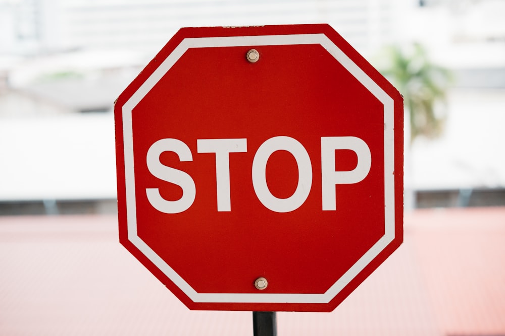 a stop sign with a red and white border