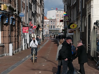 a person riding a bicycle down a busy street