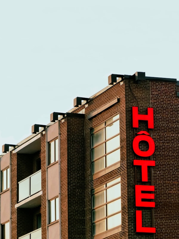 Person using laptop to book a hotel with travel savings concept