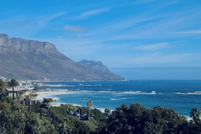 A picturesque beach scene with mountains in the background.