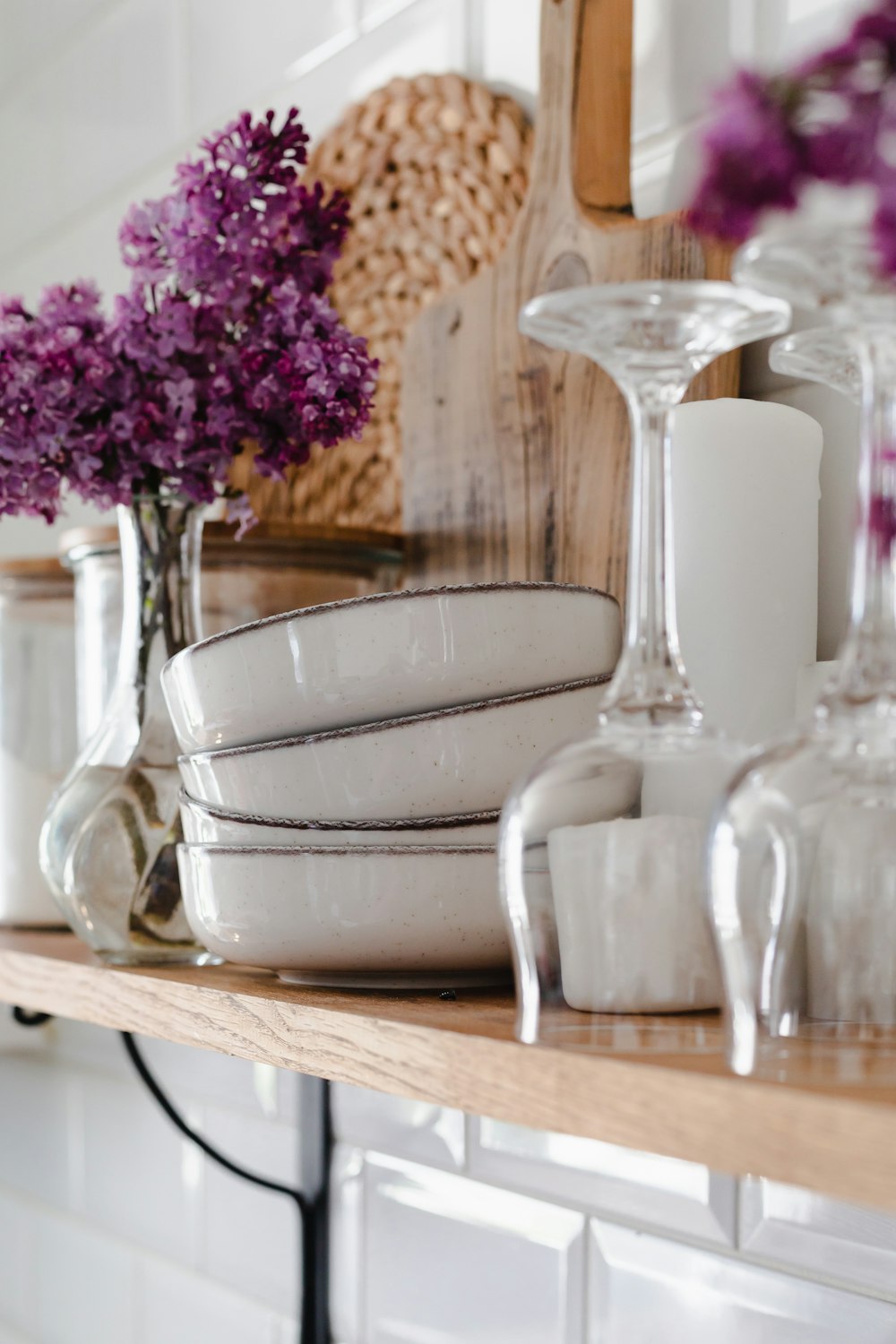 a vase with flowers on a shelf