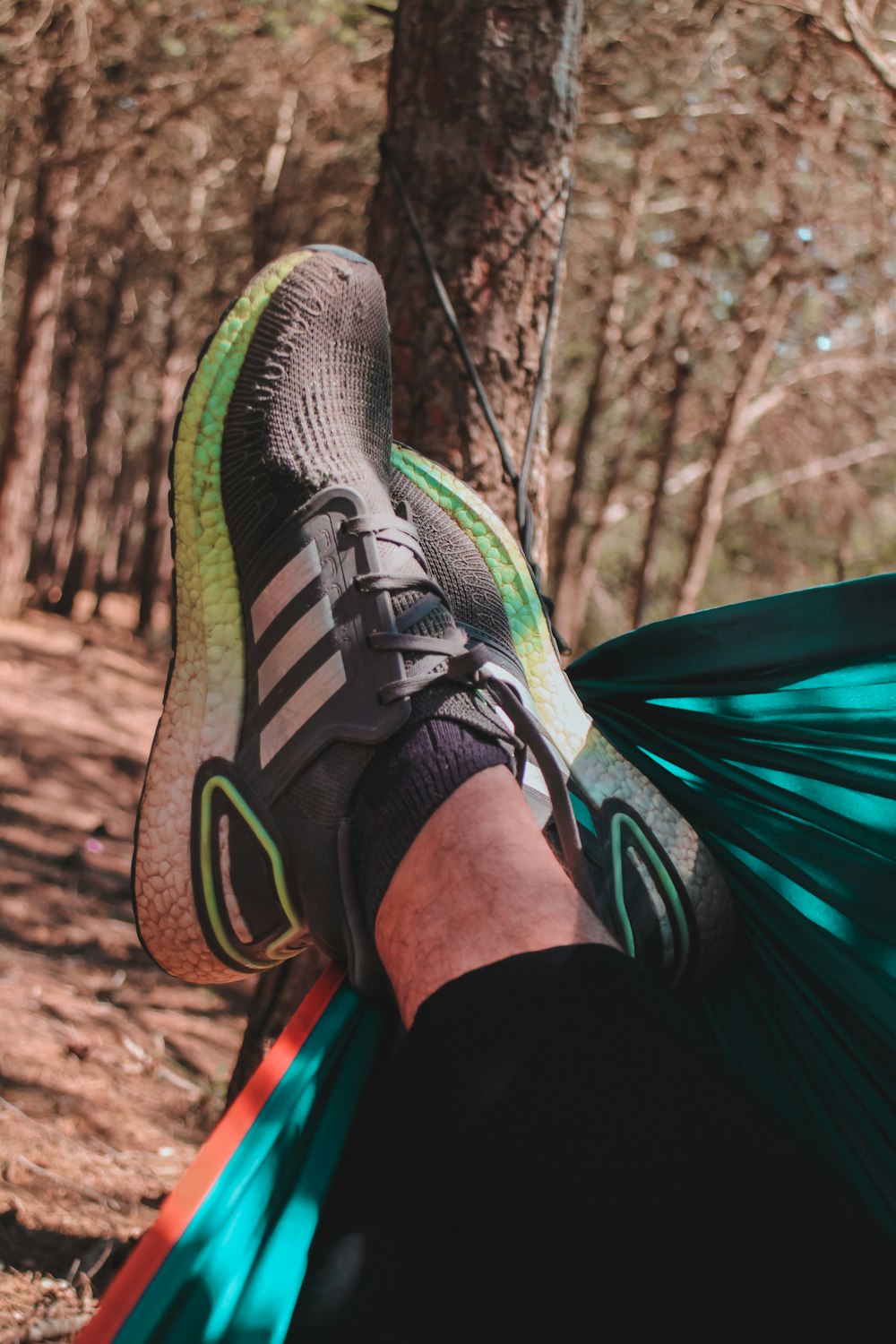 a person's feet in a shoe on a blanket