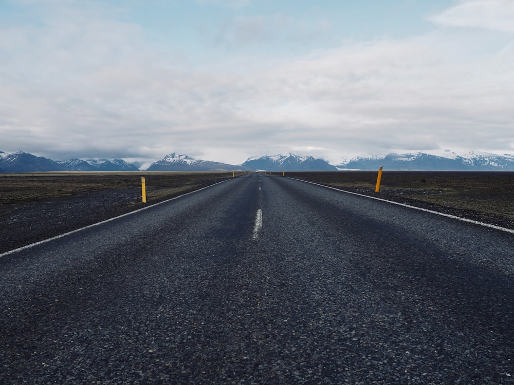 a road with mountains in the background