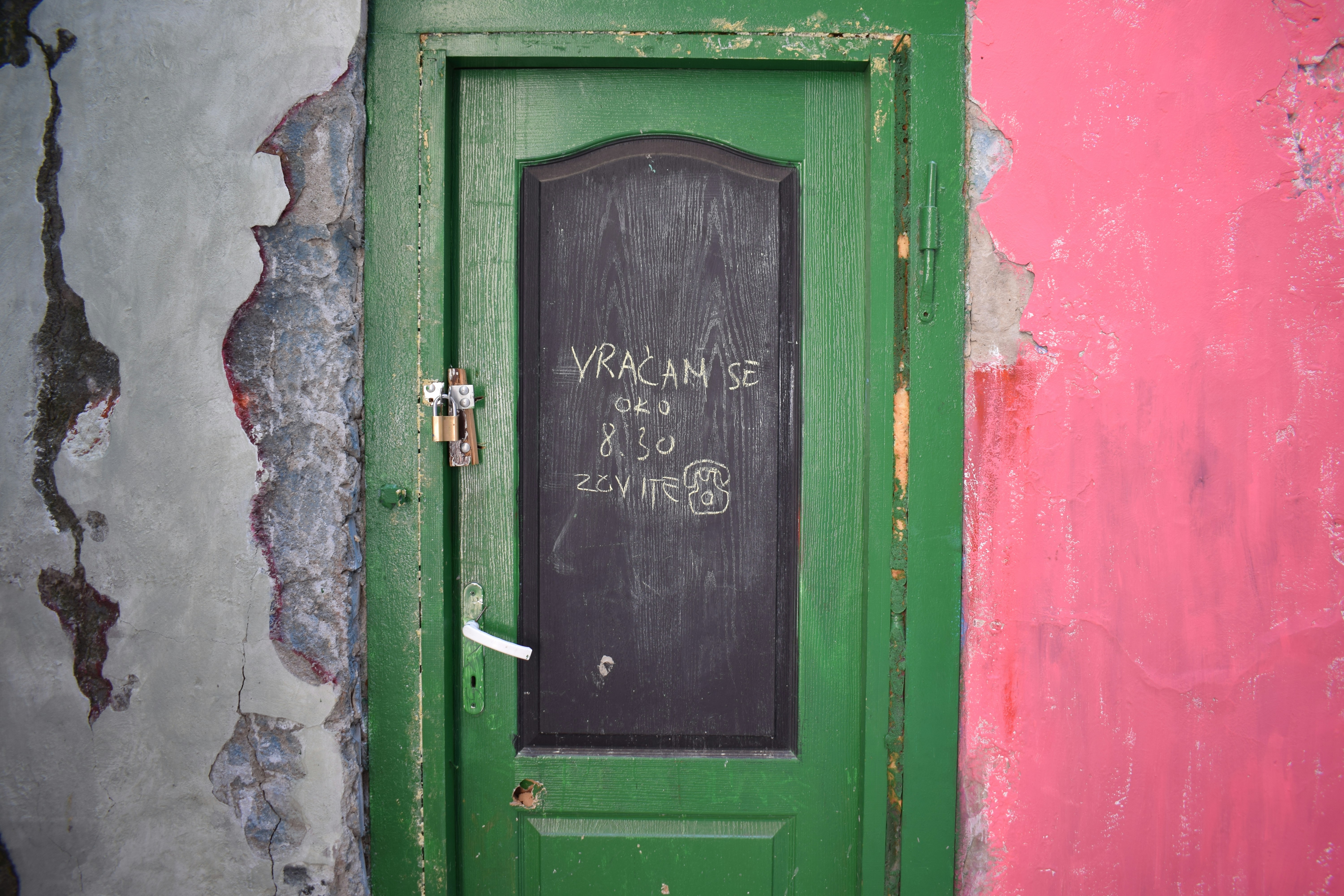a green door with a sign on it