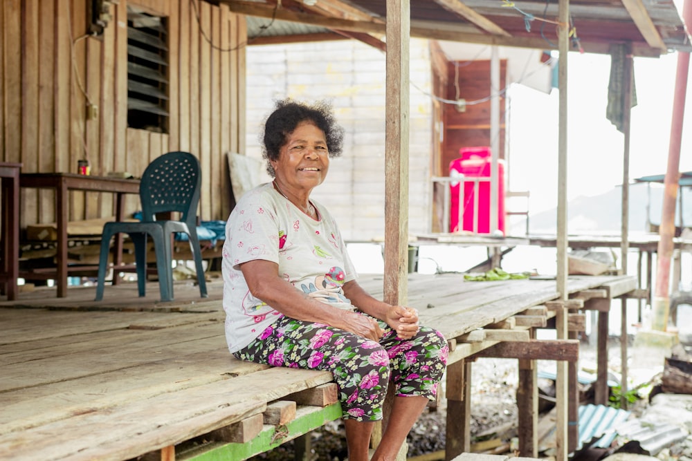 a person sitting on a wooden bench