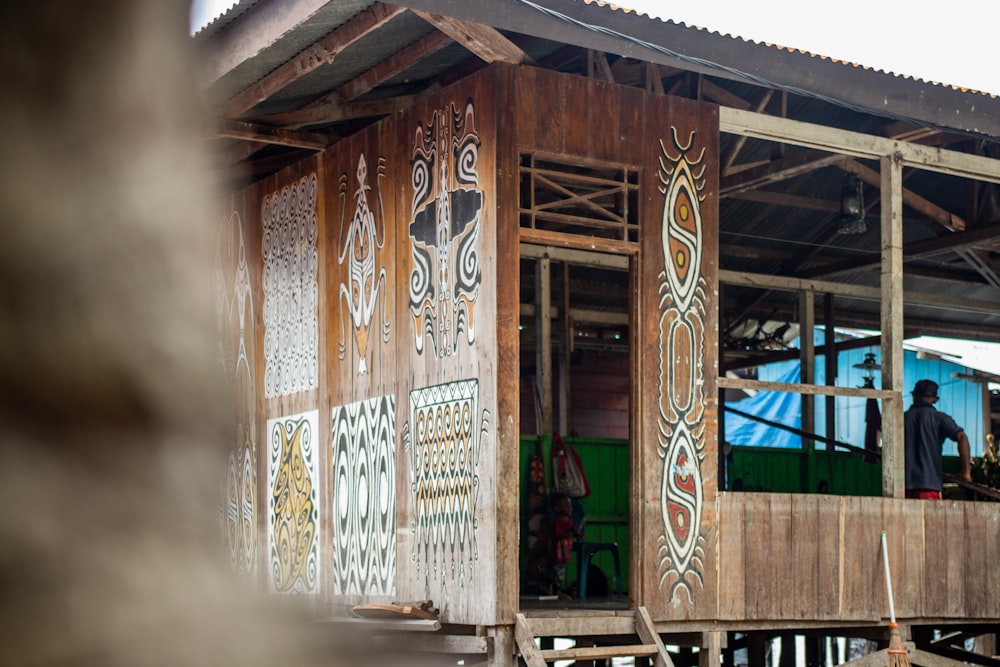 a wooden building with graffiti