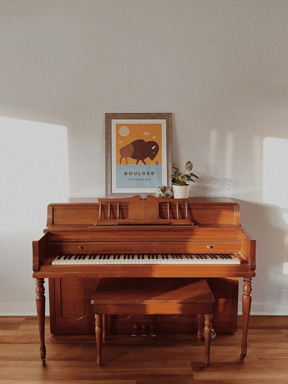a piano with a picture on the wall