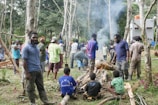 A group of diverse volunteers gathered around a campfire, planning their next environmental action.