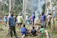 A group of people practicing survival skills in a forest setting.