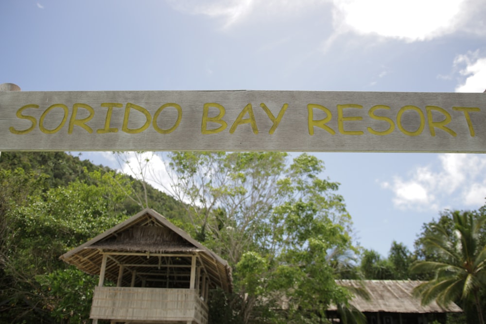 a sign with trees in the background