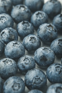 A close-up of fresh berries with ice crystals, highlighting their freshness.