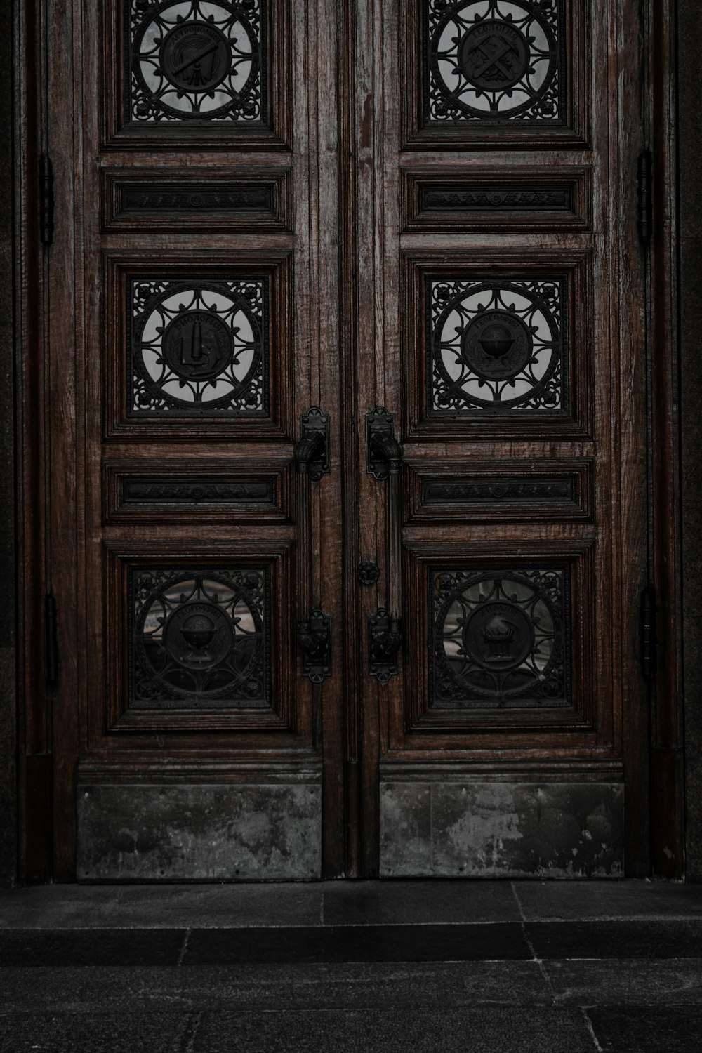 a wood door with a couple of clocks on it