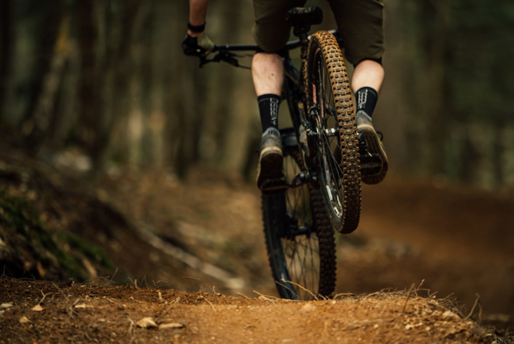 a person riding on the back of a bicycle