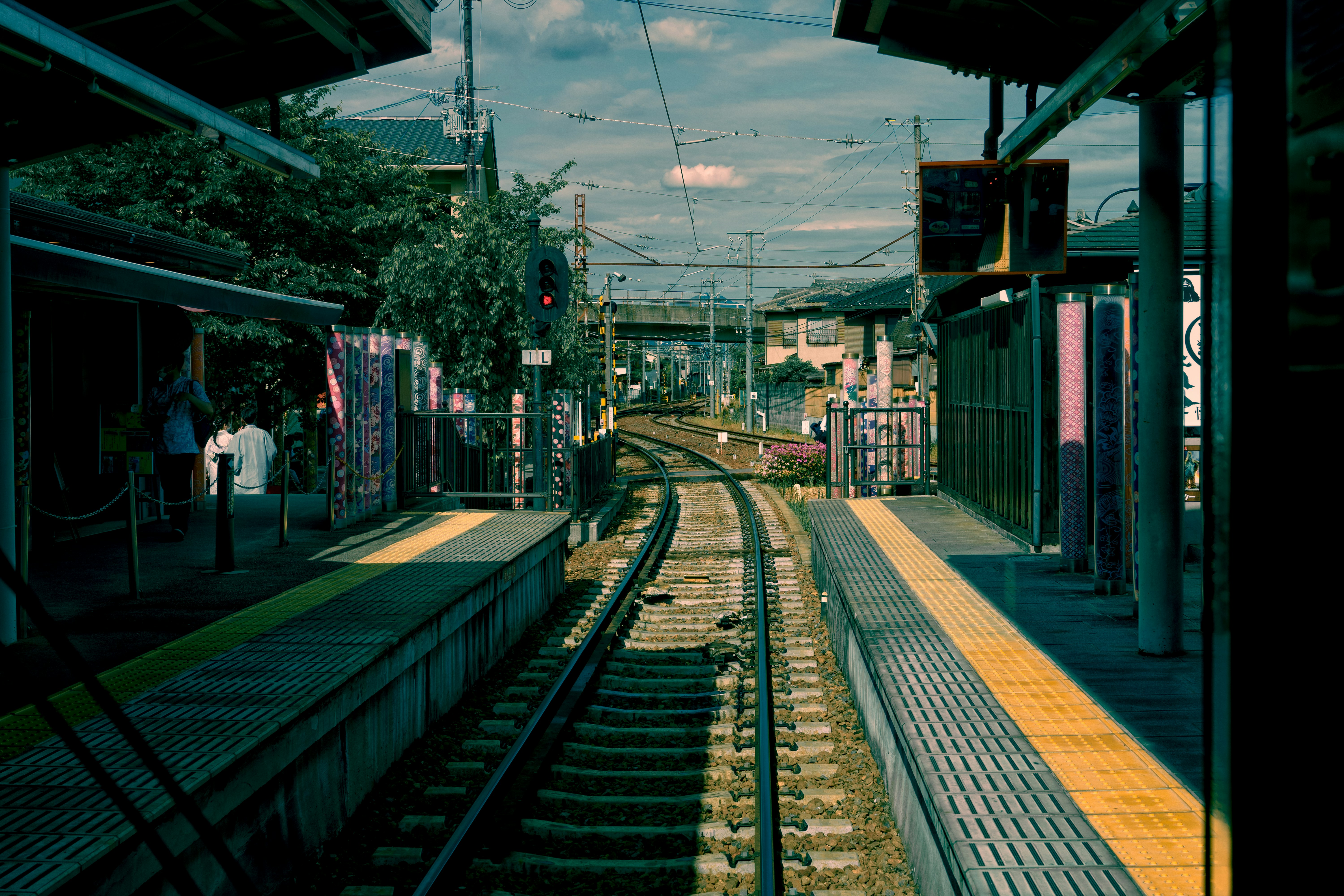 a train station with people waiting, 