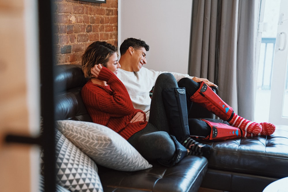 a man and woman sitting on a couch