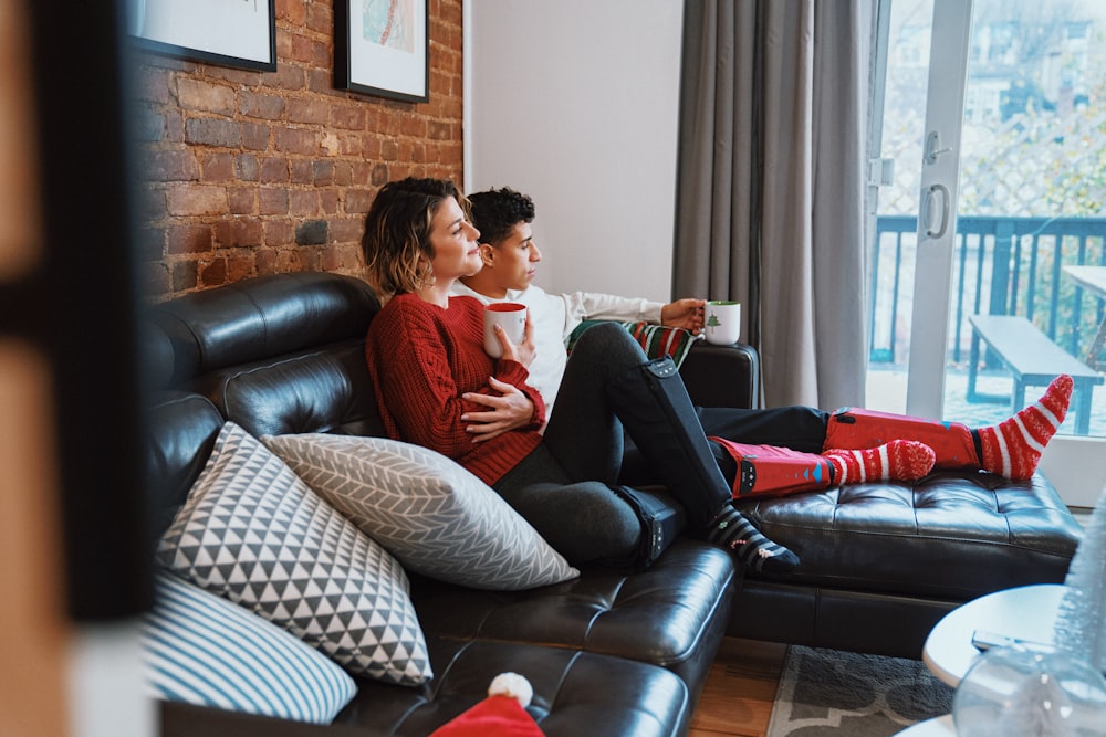 a man and woman sitting on a couch