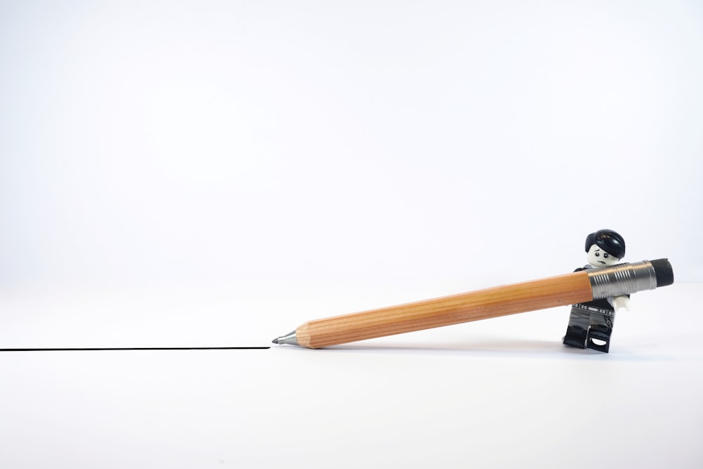 a wooden gavel with a black cap