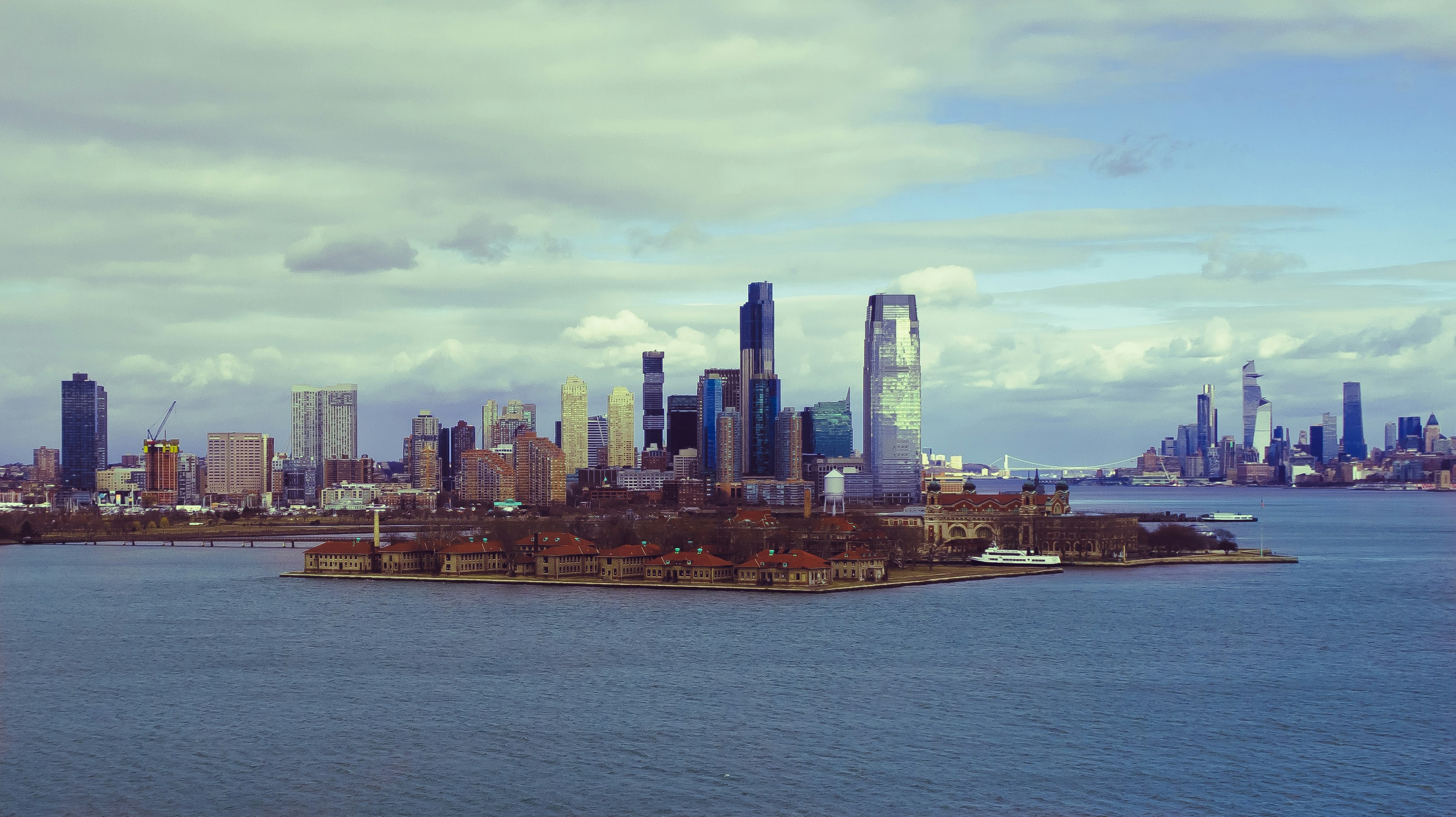 a city skyline with a body of water in the foreground