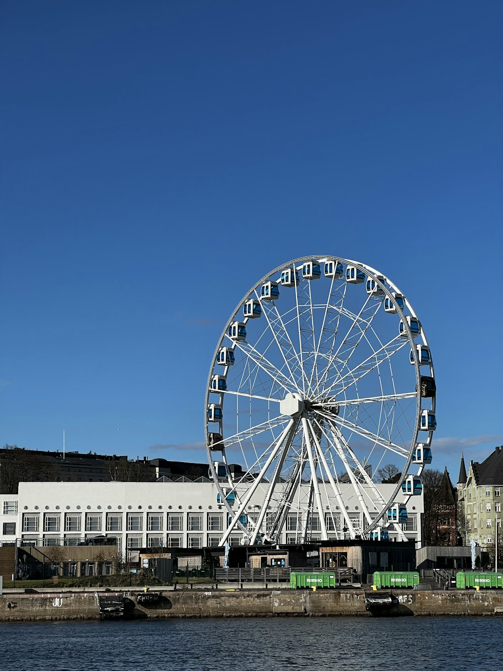 a ferris wheel by a body of water