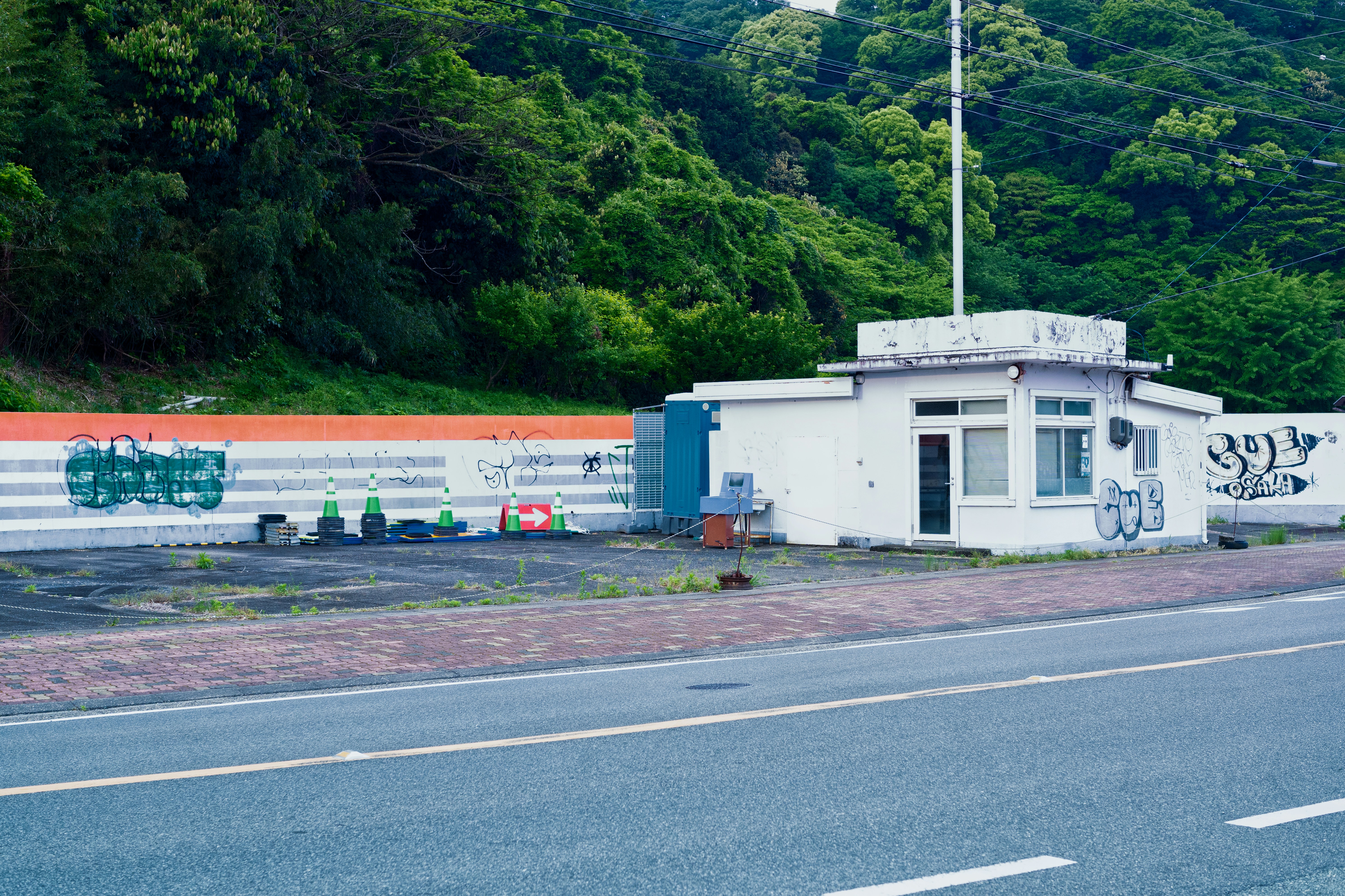 Japanese gas station with orange 灯油 sign and red kerosene tanks
